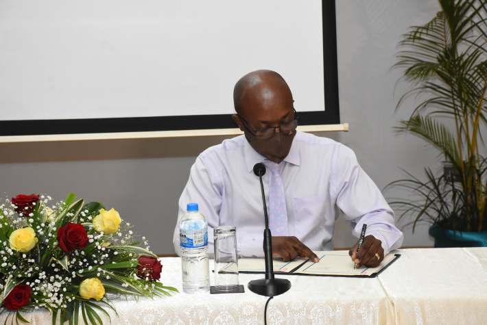 Minister Valentin signing the agreement which officially establishes IECD as a category 2 centre under the auspices of Unesco (Photo: Thomas Meriton)