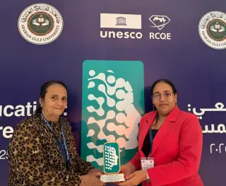 CEO proudly posing with her speakers award