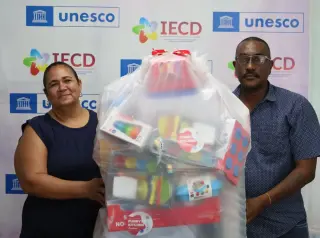 Maureen receiving donation of educational resources and toys